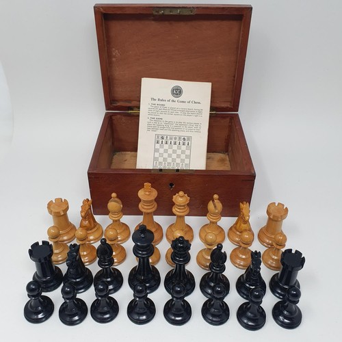 1144 - A turned wood chess set, the king 8 cm high, in a mahogany box