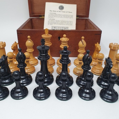 1144 - A turned wood chess set, the king 8 cm high, in a mahogany box