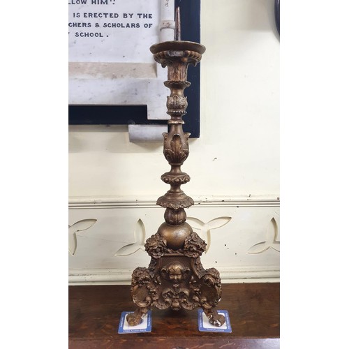 1161 - A carved gilt and gesso picket candlestick, 90 cm high