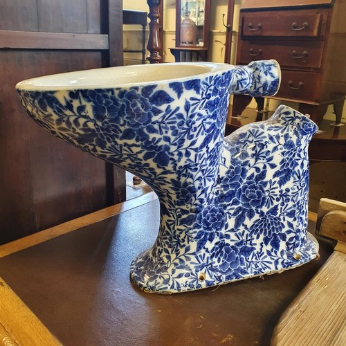 1163 - An early 20th century blue and white pottery toilet, 44 cm high, and a pine toilet seat