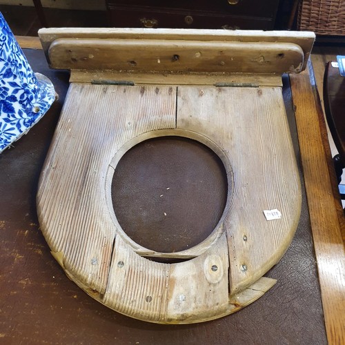 1163 - An early 20th century blue and white pottery toilet, 44 cm high, and a pine toilet seat