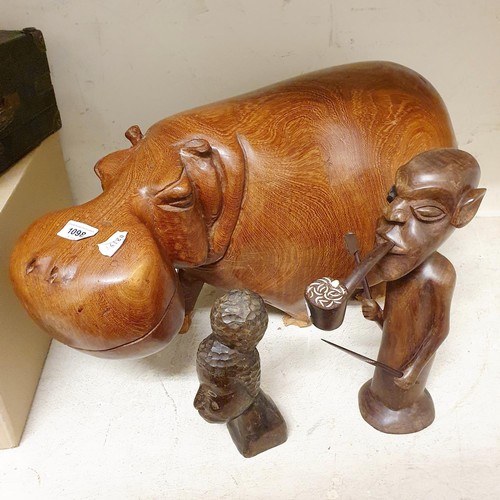 1098 - A large African carving of a hippo, 85 cm wide, and two other carvings (3)