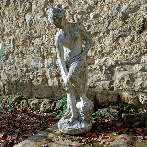 1310 - A composite stone garden statue of a lady, in a classical pose, 92 cm high