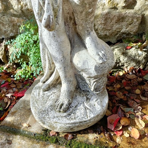 1310 - A composite stone garden statue of a lady, in a classical pose, 92 cm high