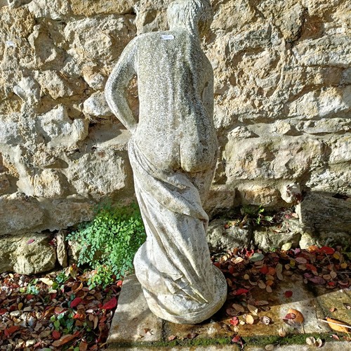 1310 - A composite stone garden statue of a lady, in a classical pose, 92 cm high