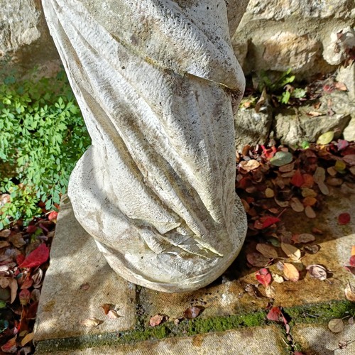 1310 - A composite stone garden statue of a lady, in a classical pose, 92 cm high