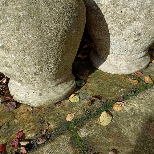 1309 - A pair of composite stone garden finials, 44 cm high