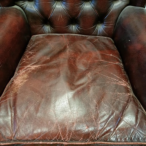 1326 - A red leather button backed wing armchair