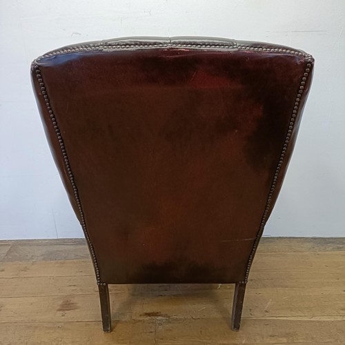 1326 - A red leather button backed wing armchair