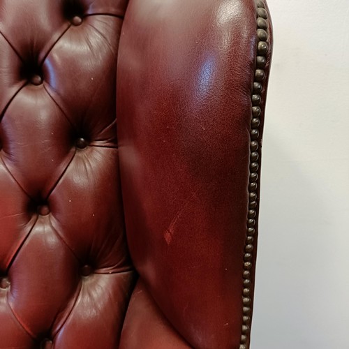 1327 - A red leather button backed wing armchair