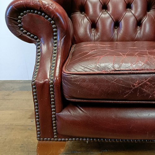 1327 - A red leather button backed wing armchair