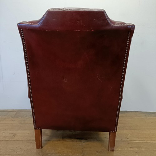 1327 - A red leather button backed wing armchair