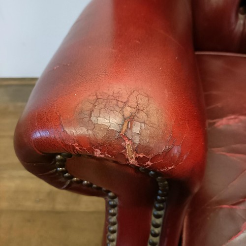 1327 - A red leather button backed wing armchair