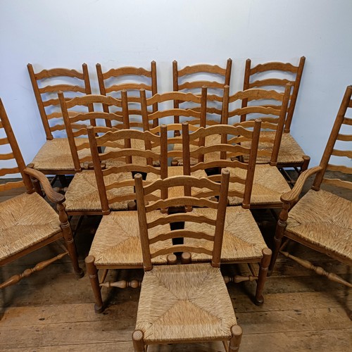 1204 - A set of twelve oak ladder back dining chairs, with reeded seats (10 +2)