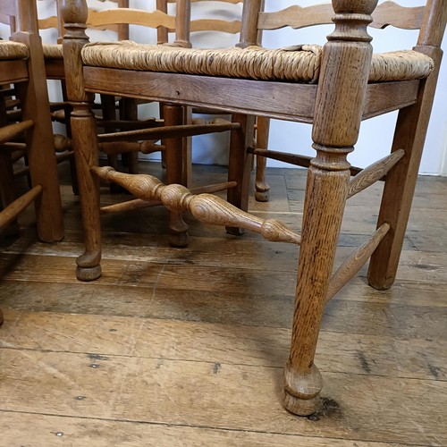 1204 - A set of twelve oak ladder back dining chairs, with reeded seats (10 +2)