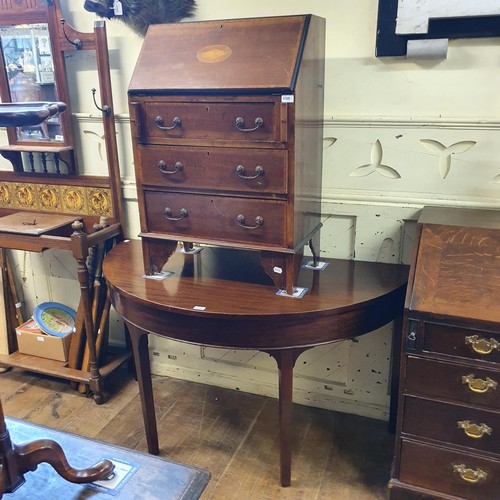 1188 - An early 20th century mahogany bureau, 60 cm wide, and a mahogany demi-lune table, 133 cm wide (2)