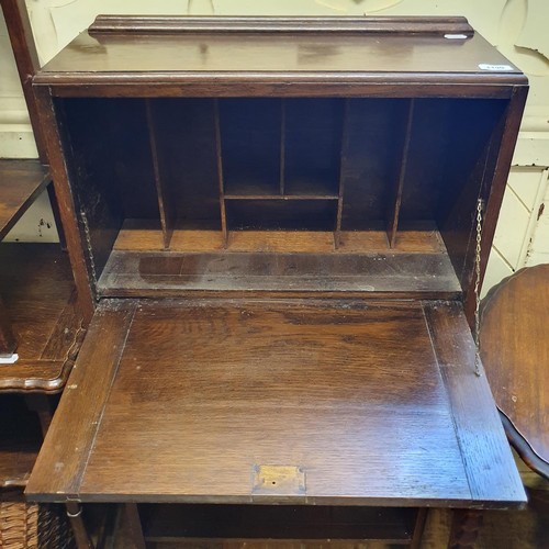 1190 - A oak student's bookcase, 61 cm wide, three tables, a wicker basket, and a walnut three tier table (... 