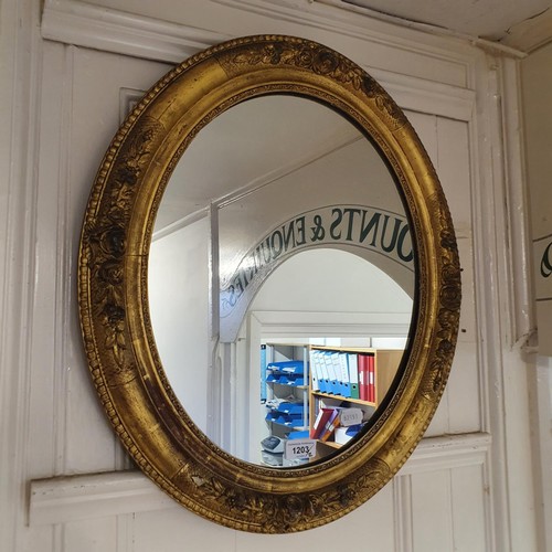 1203 - A pair of gilt gesso oval mirrors, 59 x 52 cm (2)