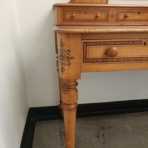 1259 - A Victorian pine dressing table, 125 cm wide and a matching bedside cupboard, 39 cm wide (2)