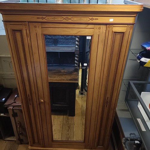 1257 - A Victorian pine wardrobe, with a mirrored door and painted decoration, 128 cm wide