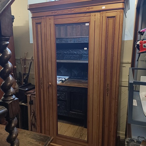 1257 - A Victorian pine wardrobe, with a mirrored door and painted decoration, 128 cm wide