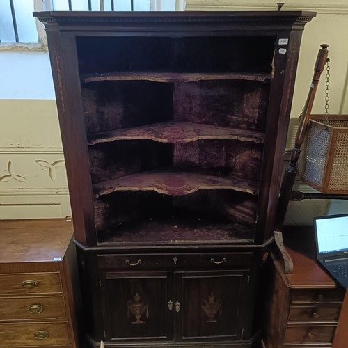 1253 - A mahogany free standing corner cabinet, 123 cm wide