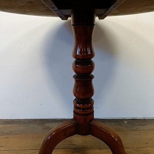 1245 - A 19th century mahogany tilt top table, on a column support tripod base, 80 cm wide, wall lights and... 