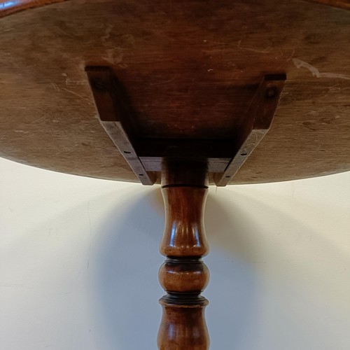 1245 - A 19th century mahogany tilt top table, on a column support tripod base, 80 cm wide, wall lights and... 