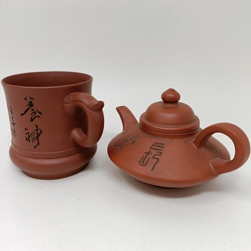 1036A - A Chinese Yixing teapot, character mark to base, 11 cm diameter, and a similar mug