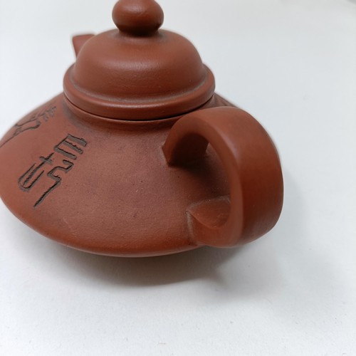 1036A - A Chinese Yixing teapot, character mark to base, 11 cm diameter, and a similar mug