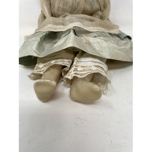 391 - A late 19th century wax head doll, 45 cm