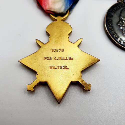 416 - A 1914-15 Star trio, awarded to 10876 Pte A Wells Wiltshire Regiment, with a memorial scroll (card b... 