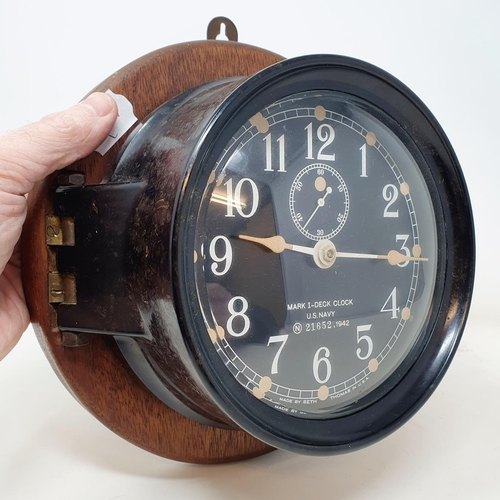 525 - A Mark I U.S. Navy Deck Clock, stamped N (within a circle) 51652, 1942, on a wooden mount, 17 cm dia... 