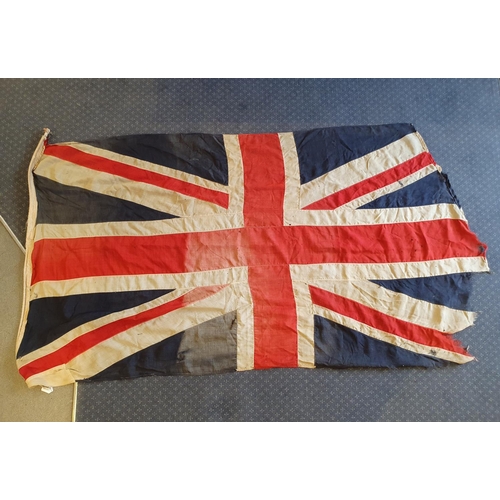 557 - A WWI era Union flag, 110 x 207 cm, general loss, wear and tears