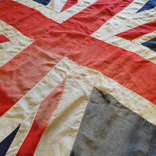 557 - A WWI era Union flag, 110 x 207 cm, general loss, wear and tears