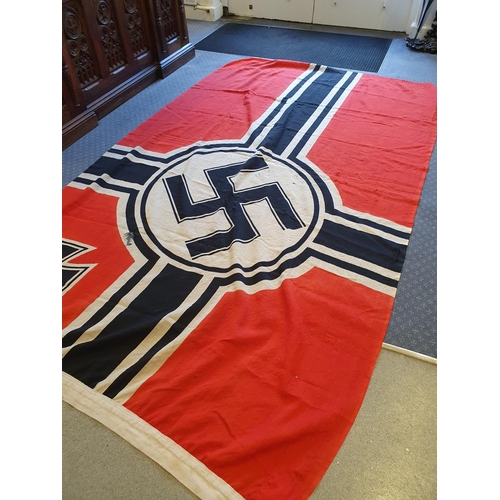 561 - A German Kriegsmarine flag, 137 x 247 cm, marked Reichskriegsflag 1.5 x 2.5 and with an eagle above ... 