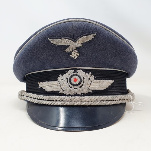 577 - A German WWII era Luftwaffe Officer Ranks visor cap, the brim with Erel makers stamp, appears to be ... 