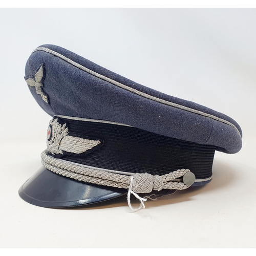 577 - A German WWII era Luftwaffe Officer Ranks visor cap, the brim with Erel makers stamp, appears to be ... 