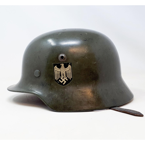 578 - A German WWII era M1935 Heer double decal helmet, the liner band is date 1938 and is a size 58, the ... 