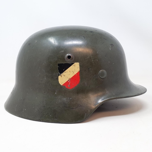 578 - A German WWII era M1935 Heer double decal helmet, the liner band is date 1938 and is a size 58, the ... 