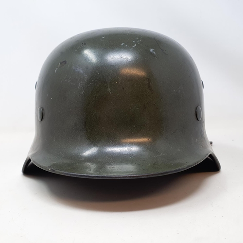 578 - A German WWII era M1935 Heer double decal helmet, the liner band is date 1938 and is a size 58, the ... 