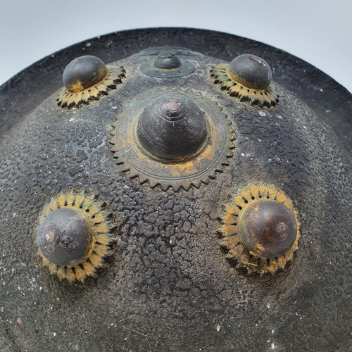 563 - An Indian hide shield or dhal shield, with gilt metal mounts, probably 19th century, 47 cm diameter
... 