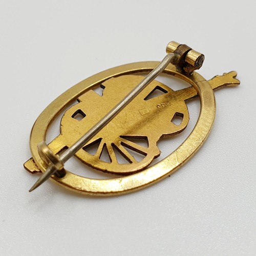 597 - A yellow metal pin, decorated a cannon, engraved St Omer 1914-1917