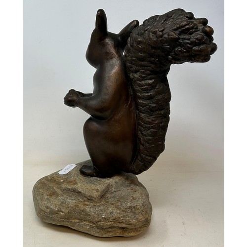 1022 - A bronze squirrel, on a carved stone base, 32 cm high