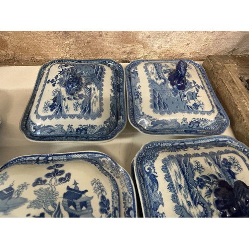 1033 - A 19th century blue and white tureen, four others and a stand (6)