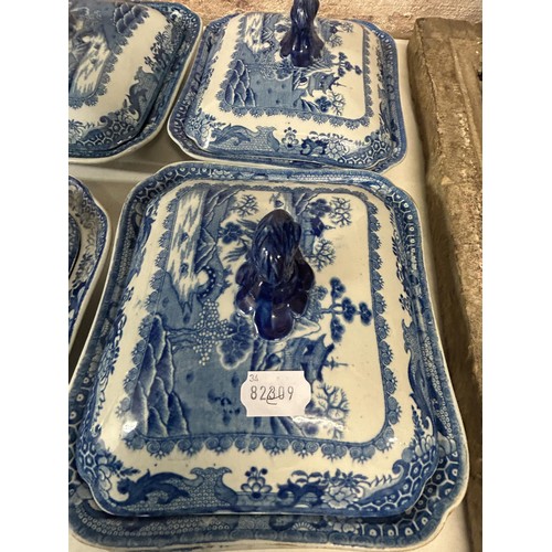 1033 - A 19th century blue and white tureen, four others and a stand (6)