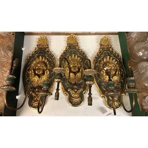 1040 - A set of three 18th century style Italian carved, painted and giltwood wall sconces, decorated cheru... 