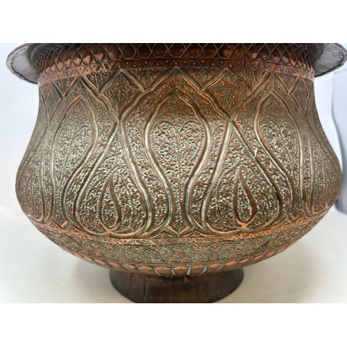 1074 - A Turkish Dallah copper coffee pot, 33 cm high, and a similar jardinière, 36 cm diameter (2)