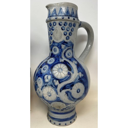 1077 - A 19th century Westerwald salt glazed jug, 30 cm high, and another similar, 30 cm high