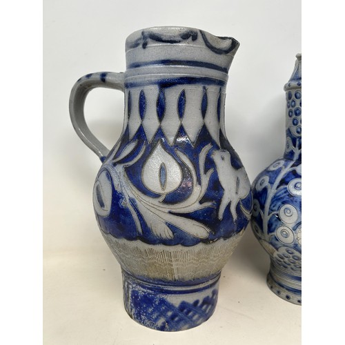 1077 - A 19th century Westerwald salt glazed jug, 30 cm high, and another similar, 30 cm high